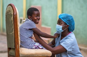 A closeup shot of a boy and a doctor wearing sanitary mask